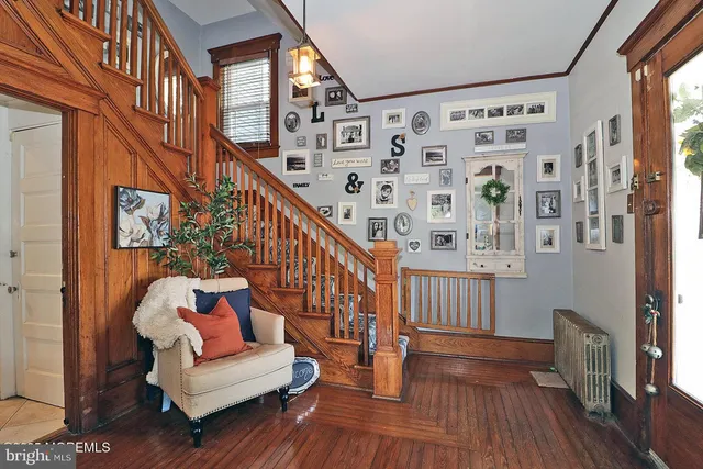 a living room with furniture ceiling fan and a flat screen tv