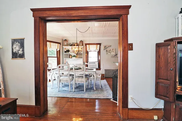 a view of a dining room with furniture wooden floor and a chandelier
