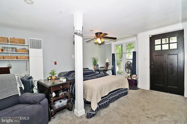 a bedroom with bed and a chandelier