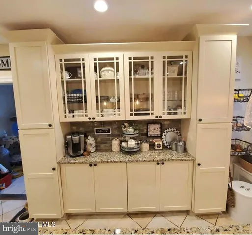 a kitchen with stainless steel appliances kitchen island granite countertop a refrigerator and a stove top oven