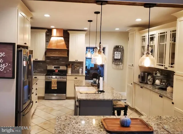 a kitchen with stainless steel appliances granite countertop a stove sink and cabinets