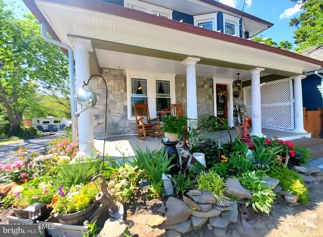 front view of a house with potted plants