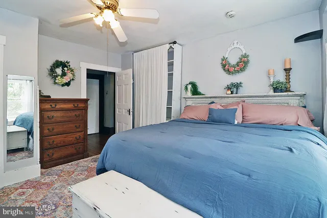 a bedroom with a bed and a chandelier