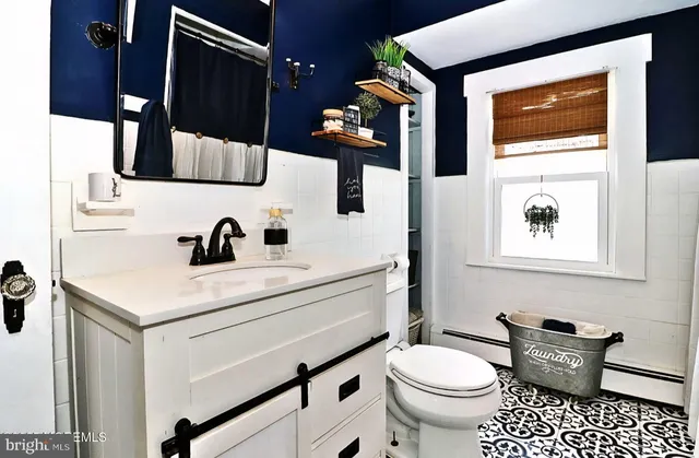 a bathroom with a sink toilet a shower and a mirror