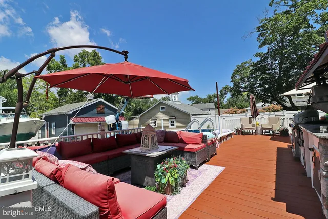 a view of a house with a patio and a yard