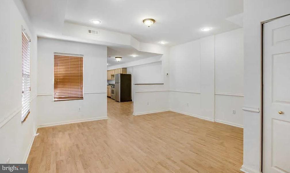 729 10th Street Northeast Washington, DC 20002 - Photo 3 of 15 a view of empty room with wooden floor and windows
