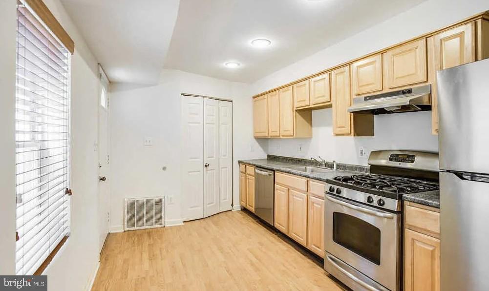 729 10th Street Northeast Washington, DC 20002 - Photo 7 of 15 a kitchen with stainless steel appliances a stove a sink and a refrigerator
