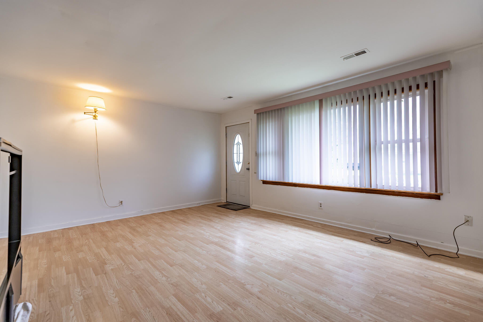 2392 Wheeler Street Gary, IN 46406 - Photo 4 of 17 an empty room with wooden floor and windows