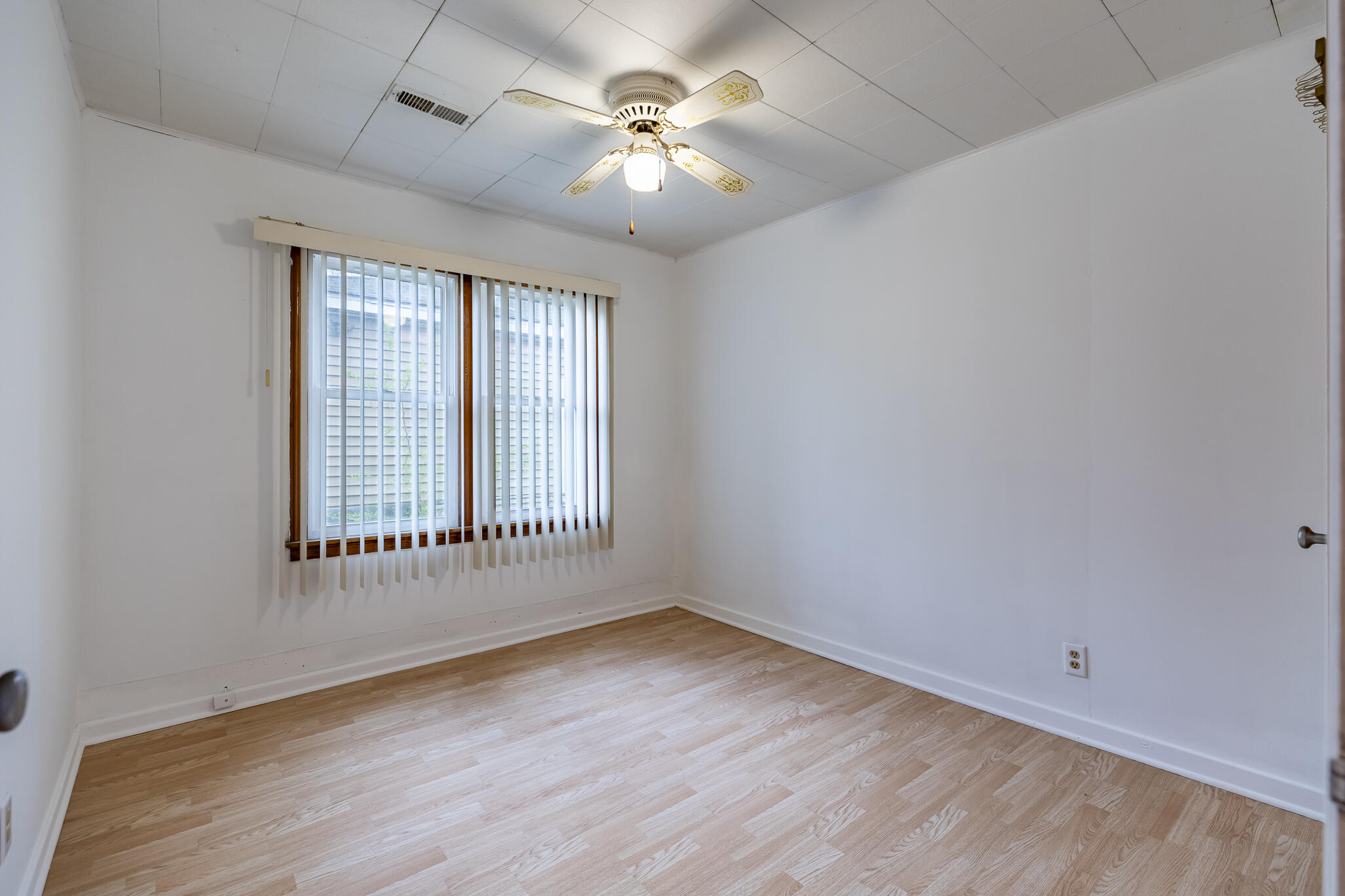 2392 Wheeler Street Gary, IN 46406 - Photo 7 of 17 an empty room with wooden floor and windows