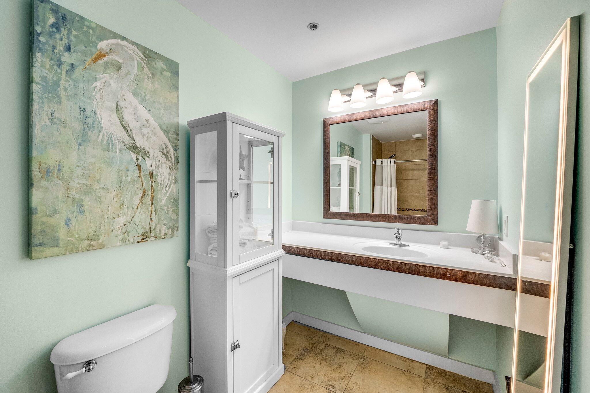 15100 Front Beach Road, Unit 517 Panama City Beach, FL 32413 - Photo 6 of 21 a bathroom with a granite countertop sink mirror and toilet