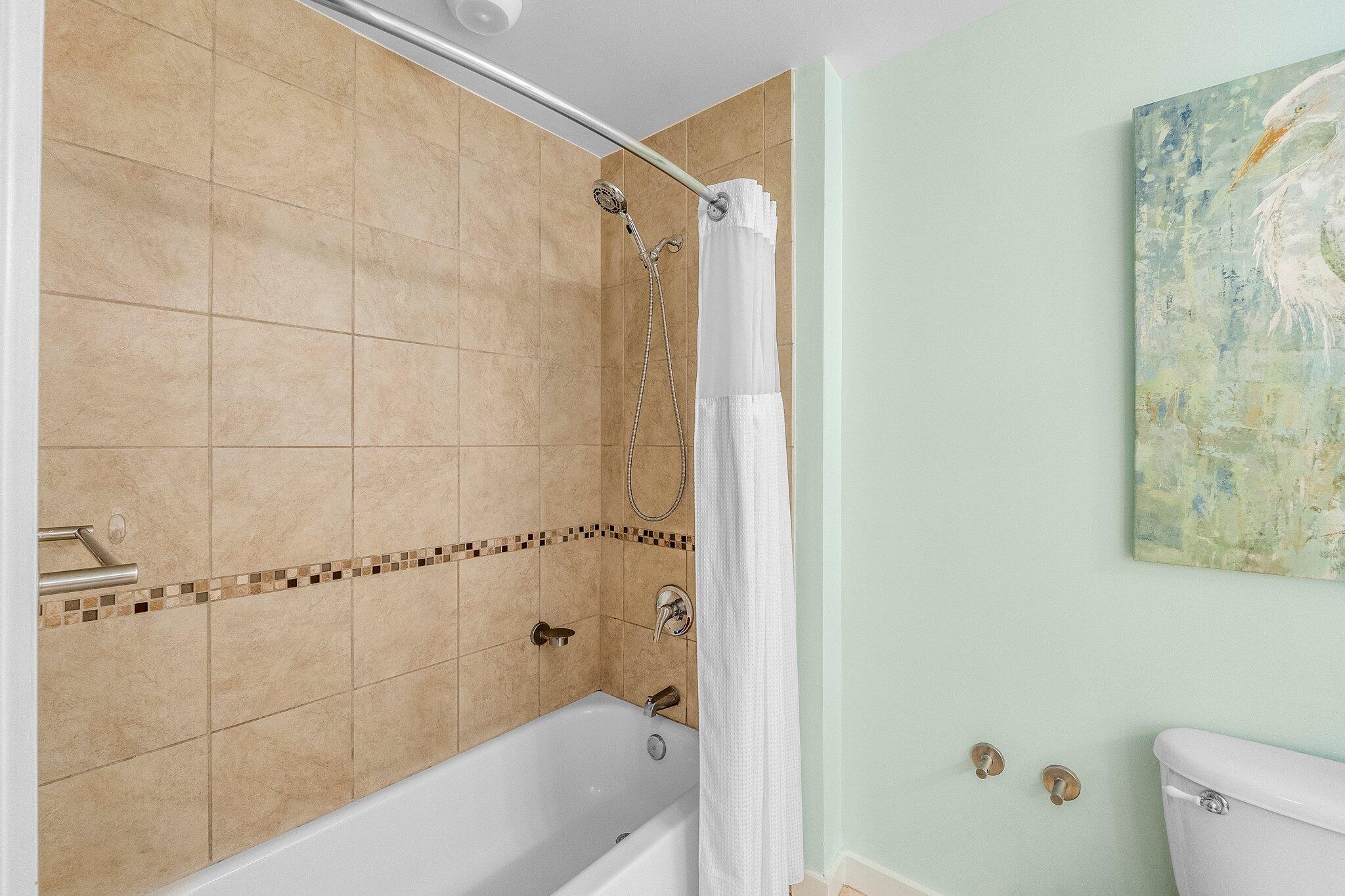 15100 Front Beach Road, Unit 517 Panama City Beach, FL 32413 - Photo 7 of 21 a bathroom with a bathtub and shower