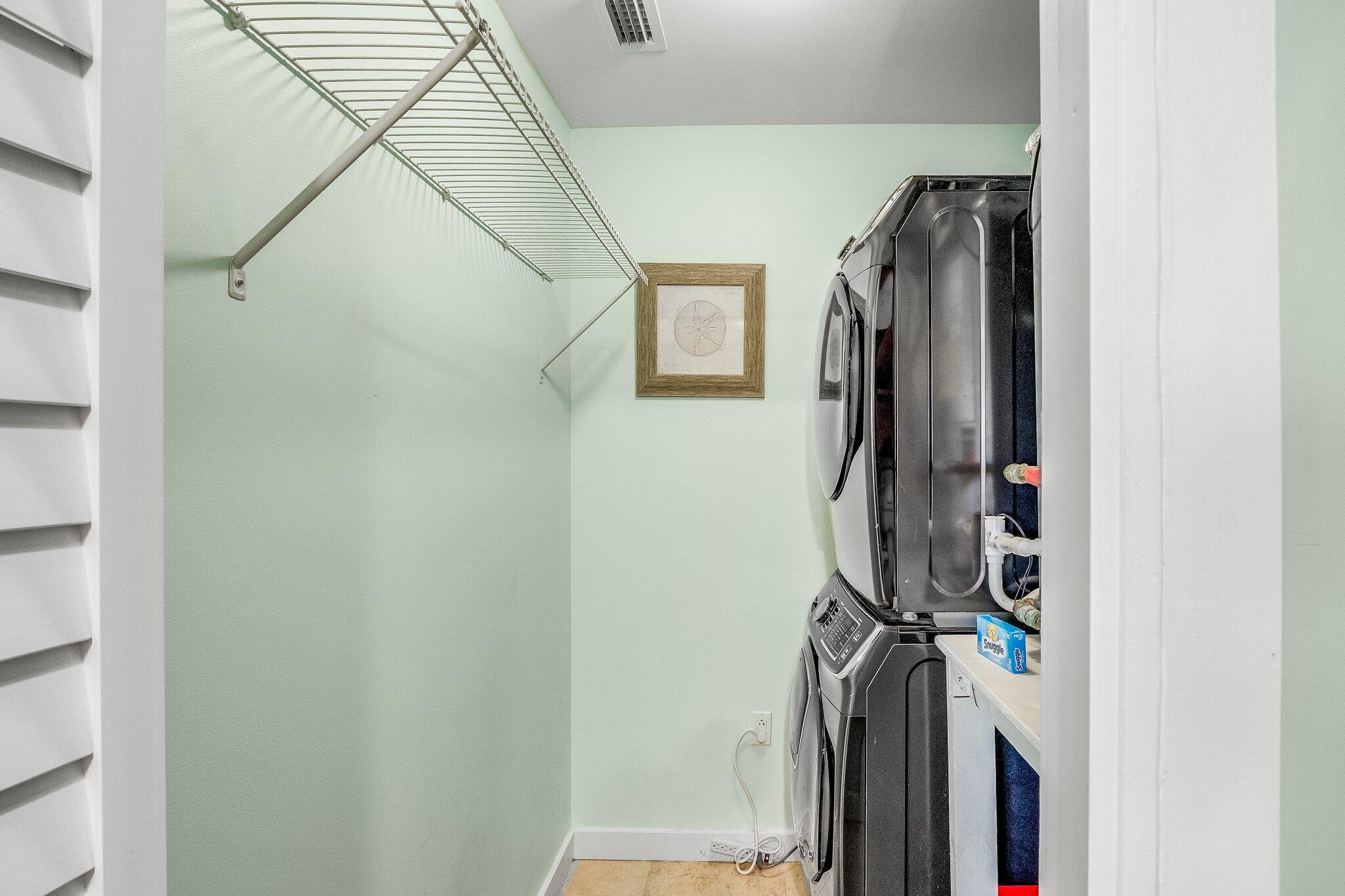 15100 Front Beach Road, Unit 517 Panama City Beach, FL 32413 - Photo 8 of 21 a view of walk in closet with clothes and shoes