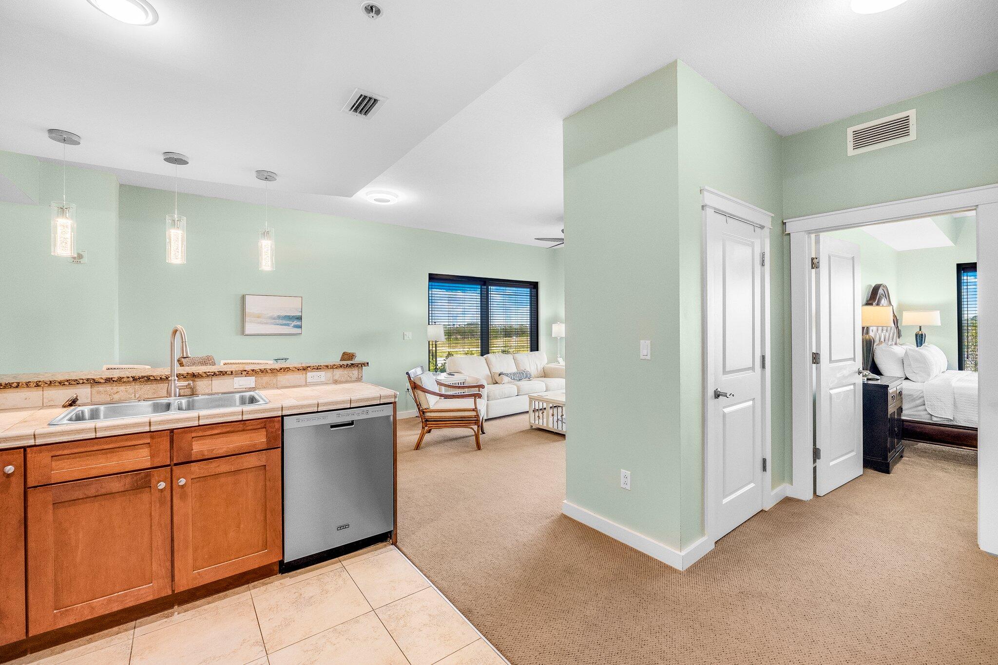 15100 Front Beach Road, Unit 517 Panama City Beach, FL 32413 - Photo 9 of 21 a view of a kitchen with a refrigerator and a sink