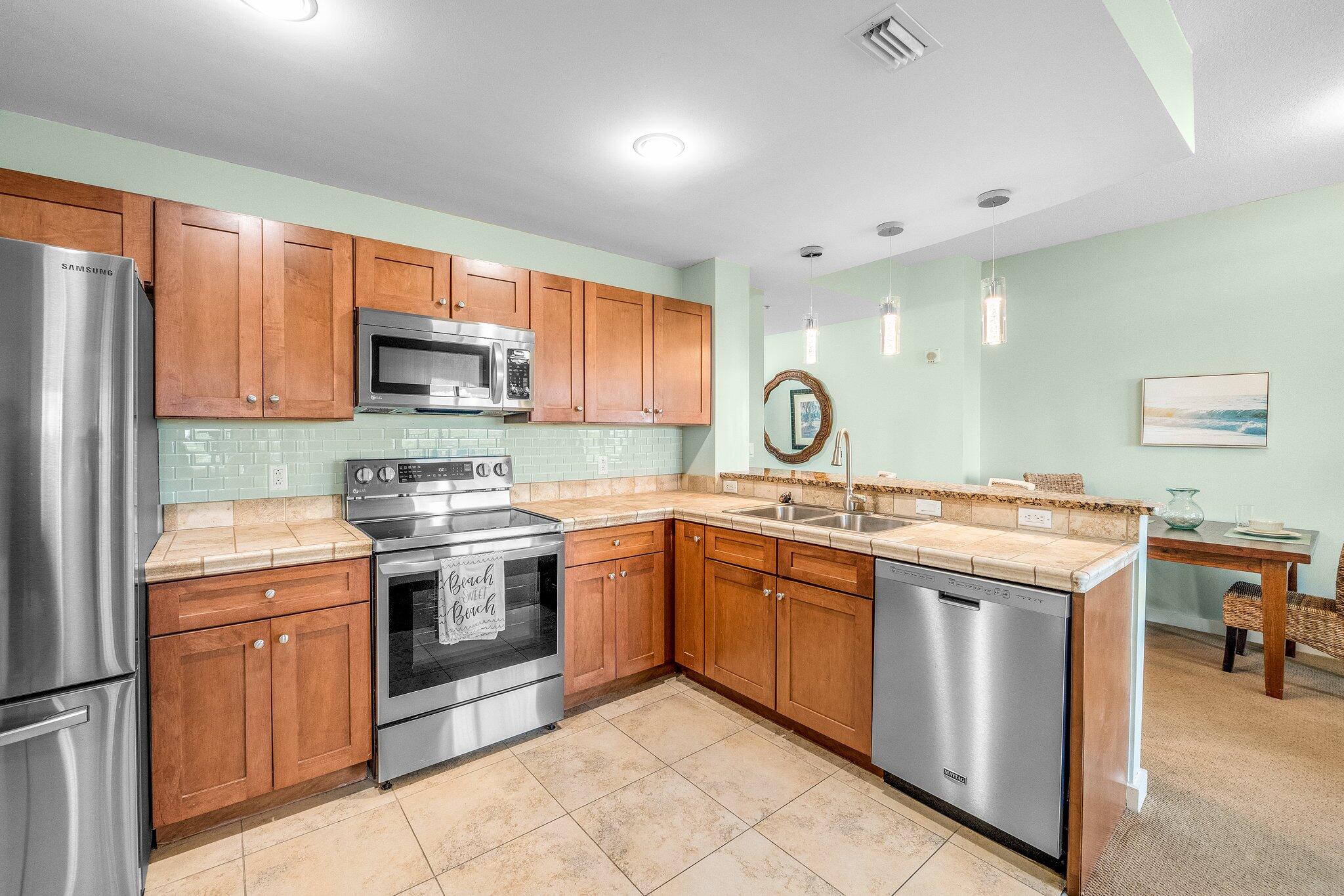 15100 Front Beach Road, Unit 517 Panama City Beach, FL 32413 - Photo 10 of 21 a kitchen with a sink stove and microwave