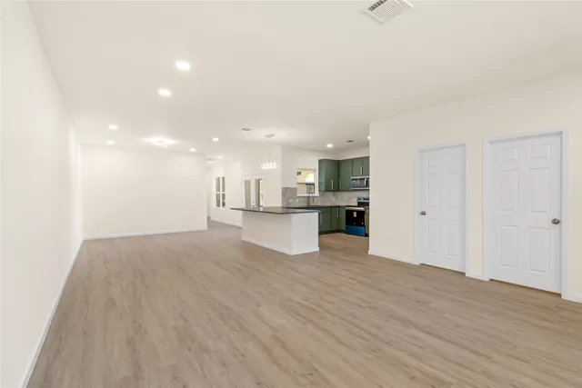 a view of hallway with closet and wooden floor