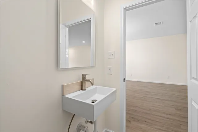 a bedroom with a large bed and a potted plant