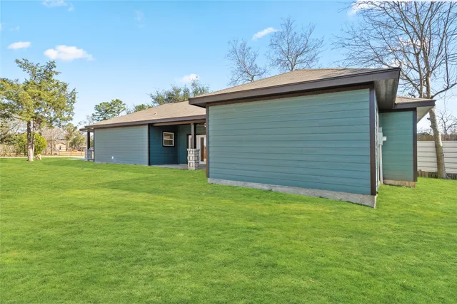 a view of kitchen with kitchen island wooden floor center island and stainless steel appliances