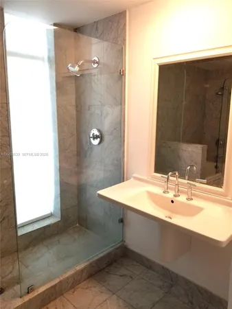a bathroom with a bathtub sink and mirror