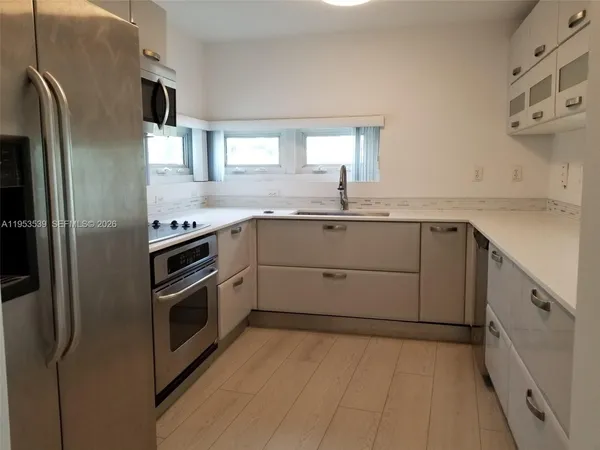 a kitchen with stainless steel appliances a refrigerator stove and microwave