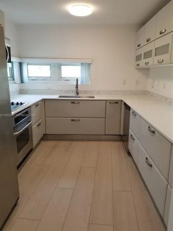 a kitchen with a stove microwave and sink