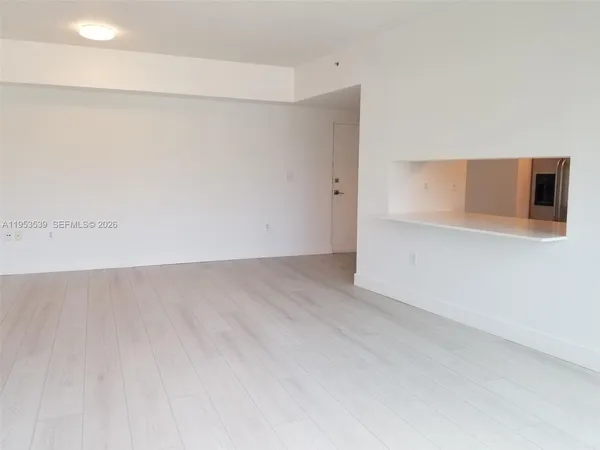 a view of a room with wooden floor
