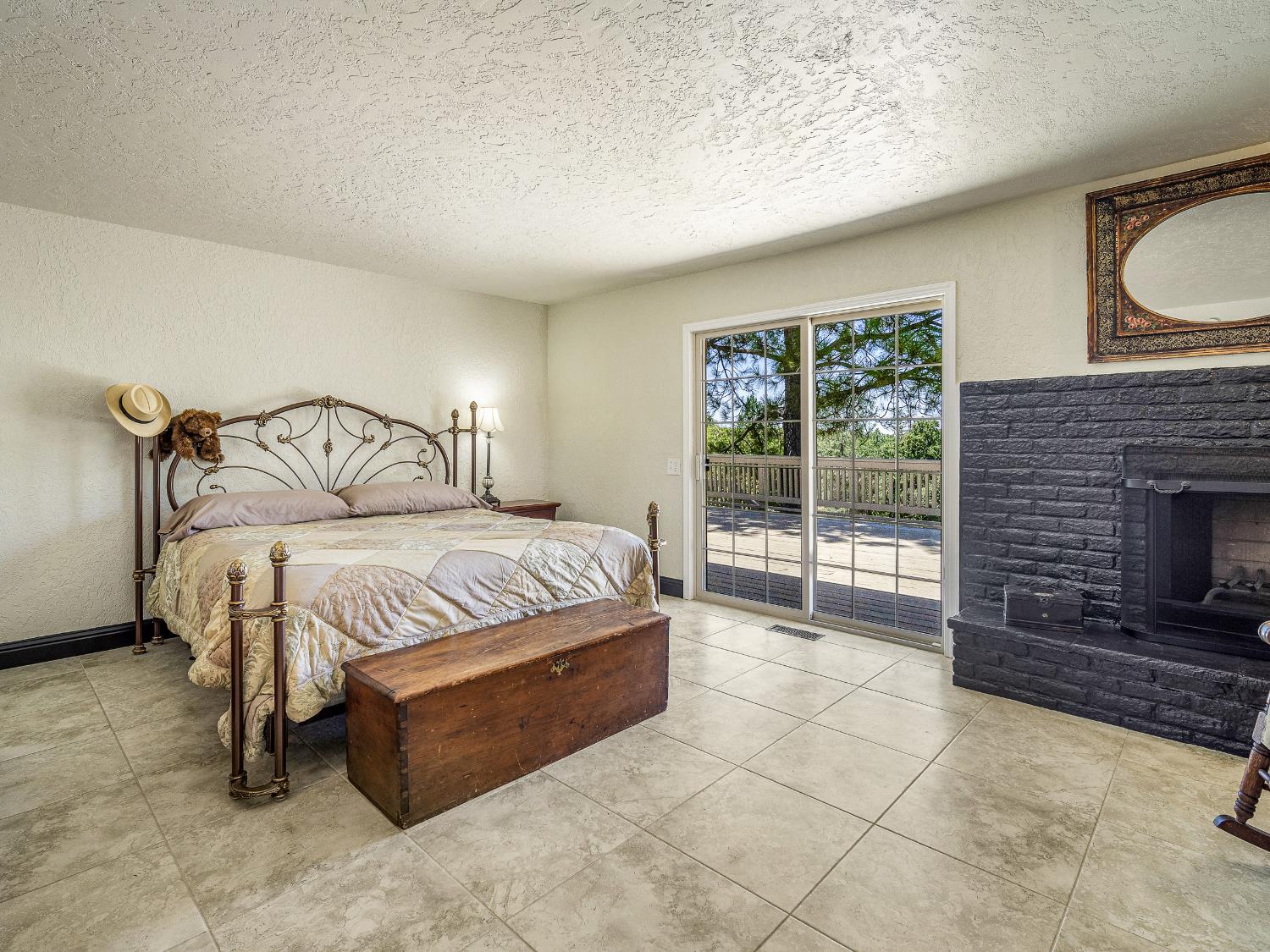 17065 Niles Road Jackson, CA 95642 - Photo 20 of 26 a bedroom with a bed and a fireplace