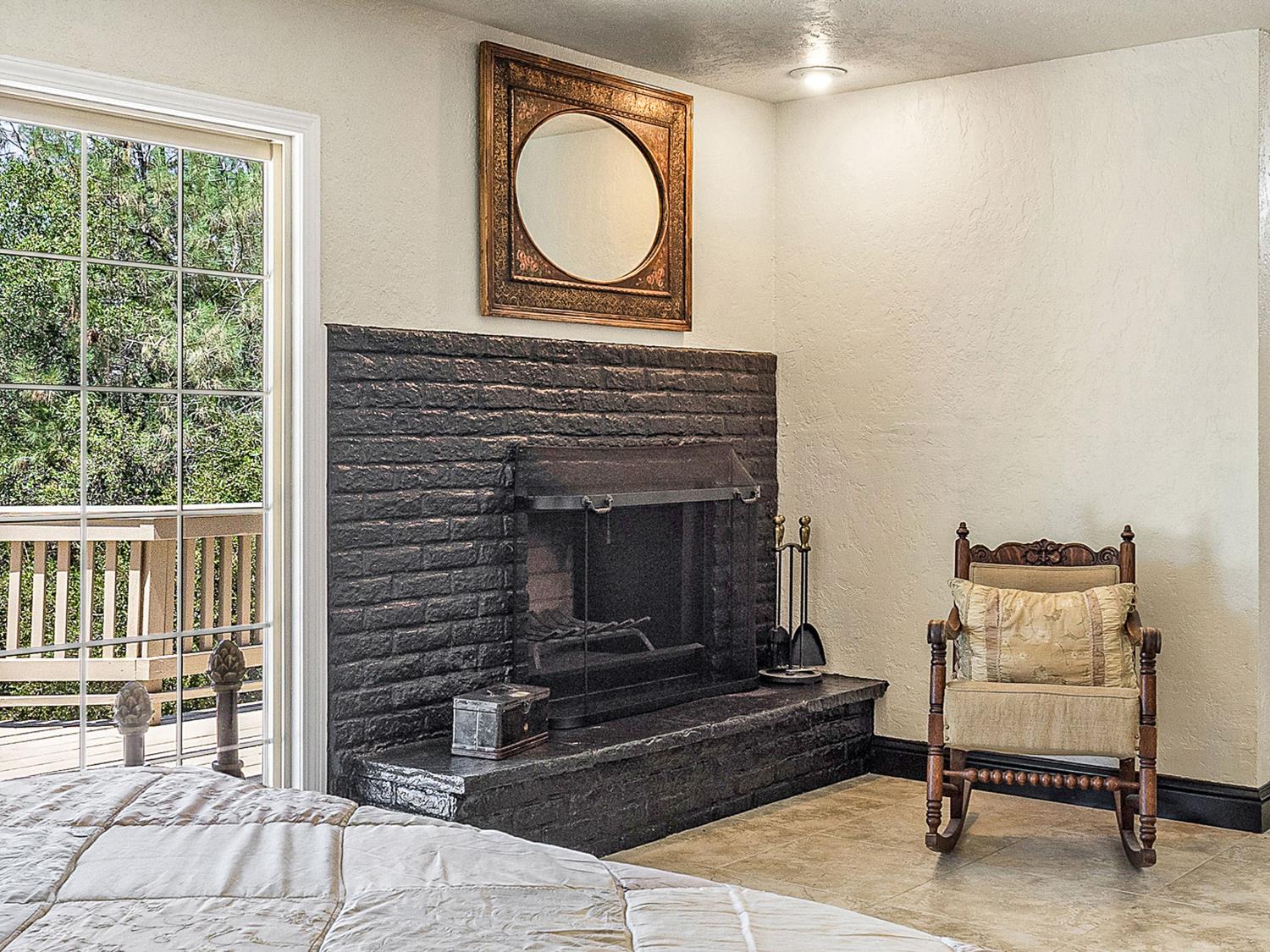 17065 Niles Road Jackson, CA 95642 - Photo 21 of 26 a living room with furniture a window and a fireplace