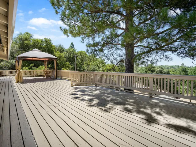 a view of a wooden deck next to a yard