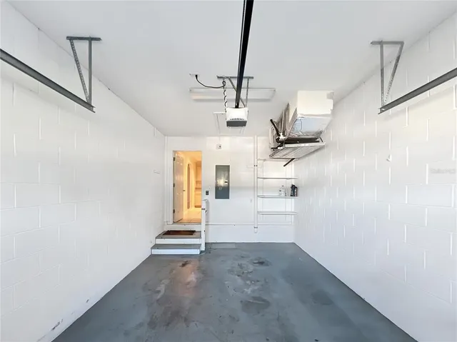 an aerial view of a house with a garden and lake view