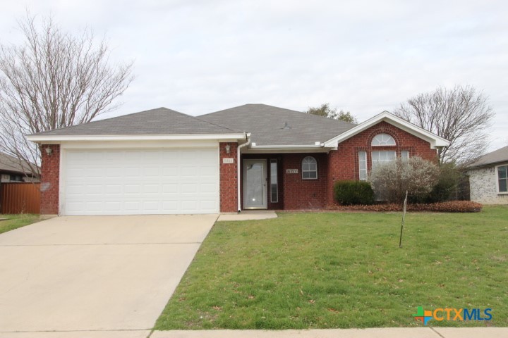 5211 James Loop Killeen, TX 76542 - Photo 1 of 18 a front view of a house with a yard and garage