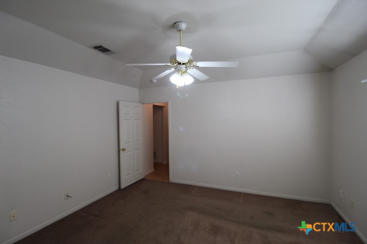 5211 James Loop Killeen, TX 76542 - Photo 13 of 18 an empty room with a fan and a chandelier fan