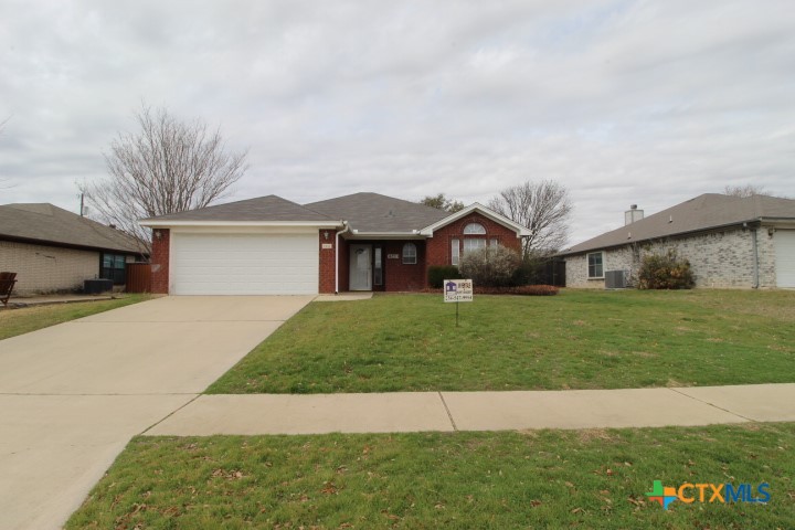 5211 James Loop Killeen, TX 76542 - Photo 2 of 18 a front view of a house with a garden and yard