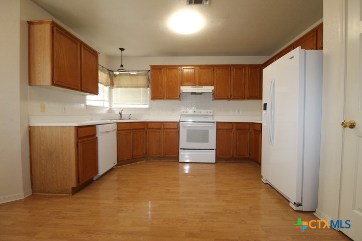 5211 James Loop Killeen, TX 76542 - Photo 3 of 18 a kitchen with stainless steel appliances granite countertop a stove a sink dishwasher and a refrigerator