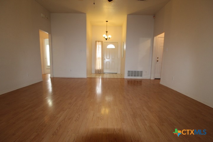 5211 James Loop Killeen, TX 76542 - Photo 5 of 18 a view of an empty room with wooden floor and a window