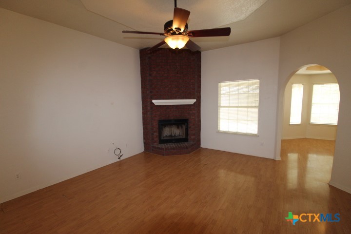 5211 James Loop Killeen, TX 76542 - Photo 6 of 18 a view of an empty room with window chandelier fan and fire place