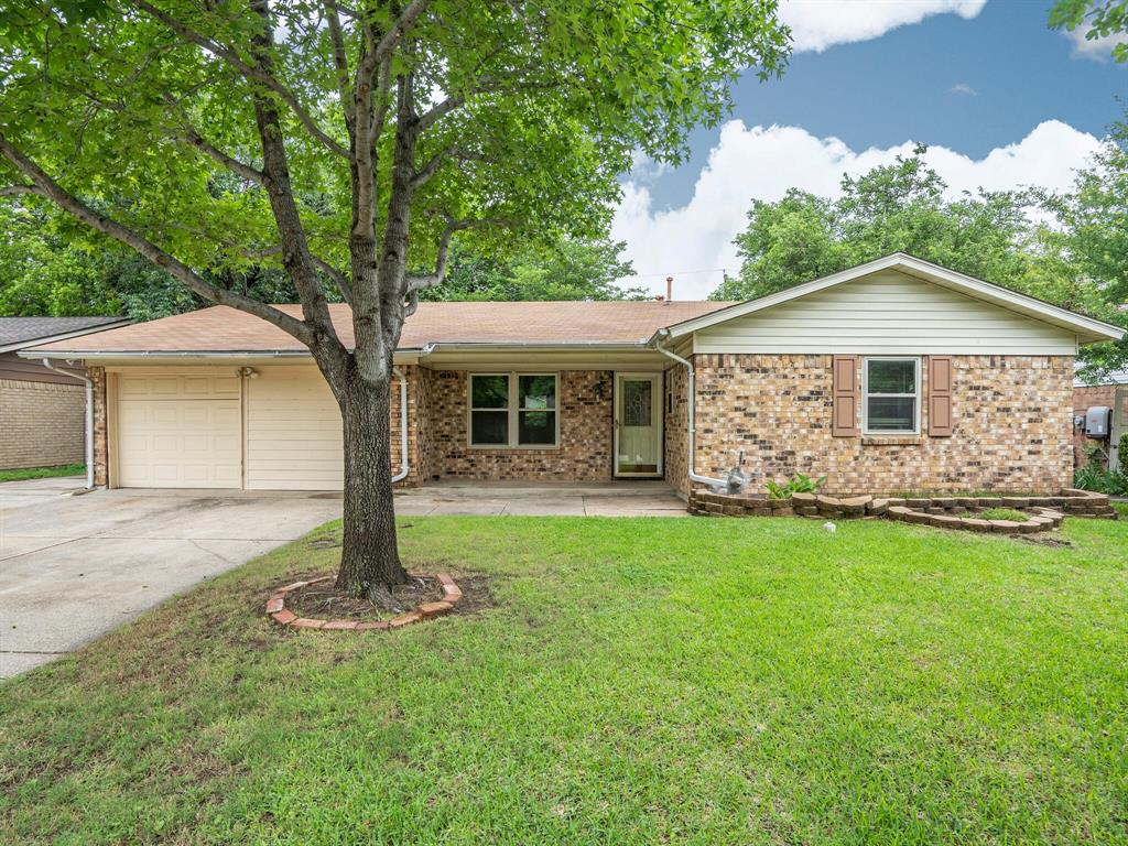 3325 Hummingbird Lane Denton, TX 76209 - Photo 1 of 1 a front view of a house with a yard