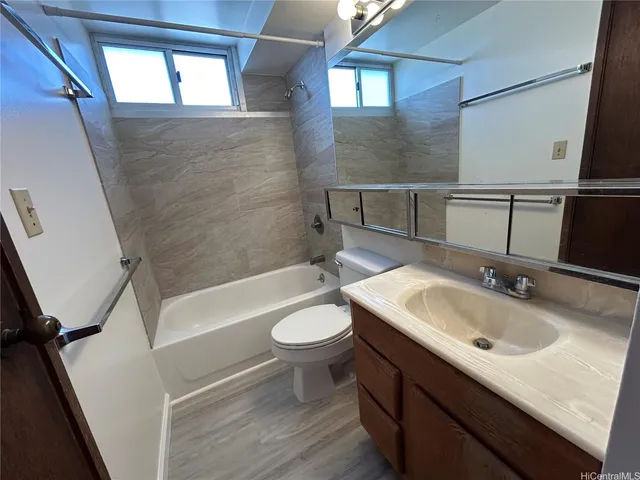 a bathroom with a sink a toilet and bathtub