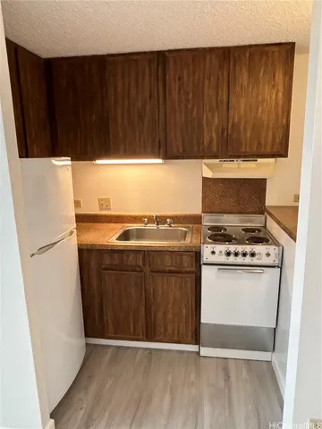 a kitchen with a refrigerator and a stove
