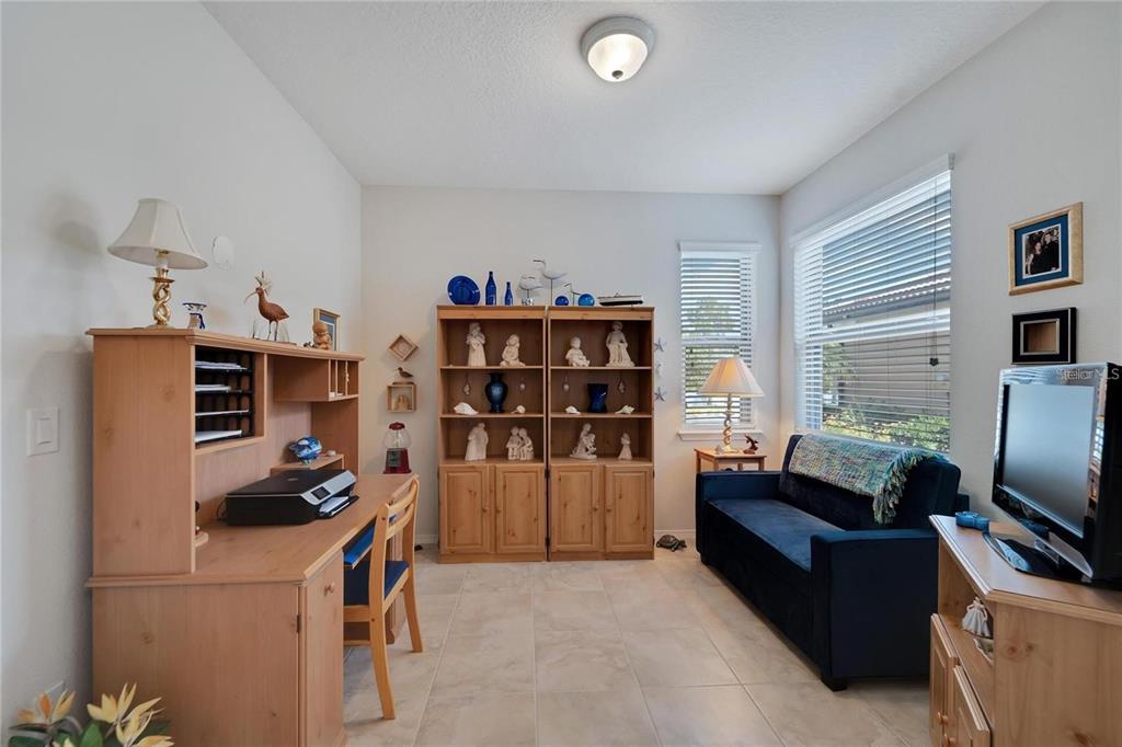 428 Seneca Falls Drive Apollo Beach, FL 33572 - Photo 10 of 31 a living room with furniture a flat screen tv and a refrigerator