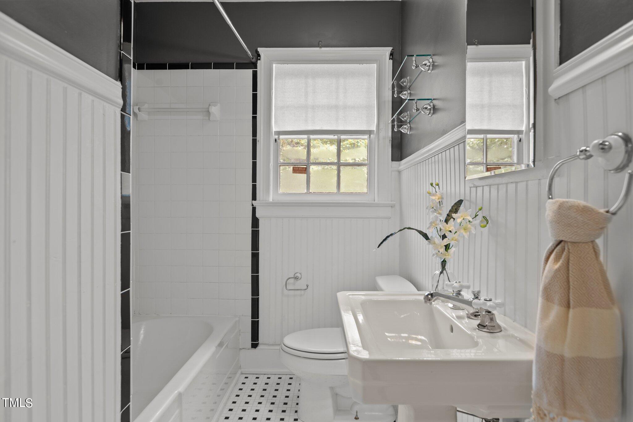 1702 James Street Durham, NC 27707 - Photo 11 of 40 a bathroom with a sink a toilet and shower