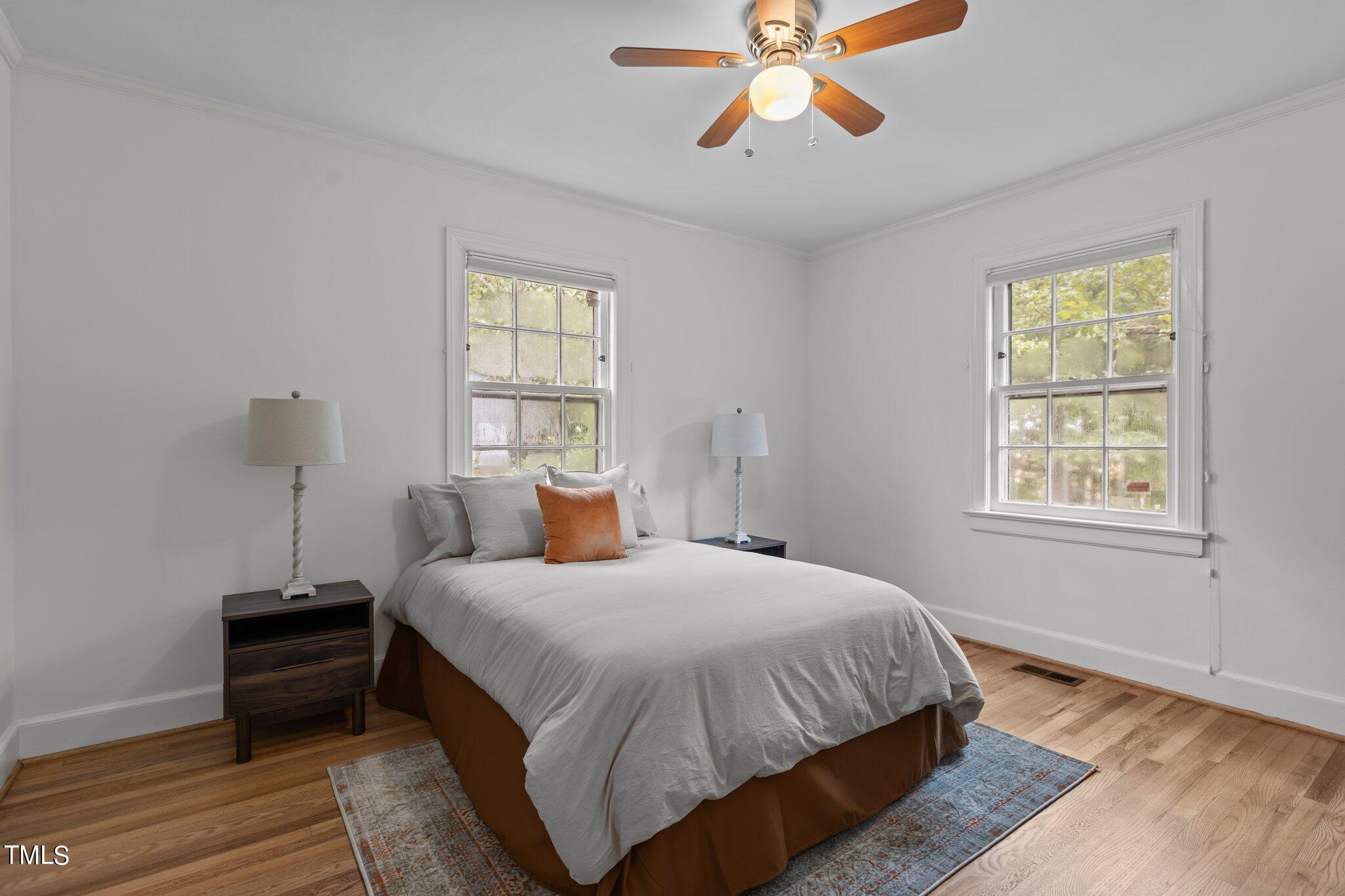 1702 James Street Durham, NC 27707 - Photo 13 of 40 a bedroom with a bed and wooden floor