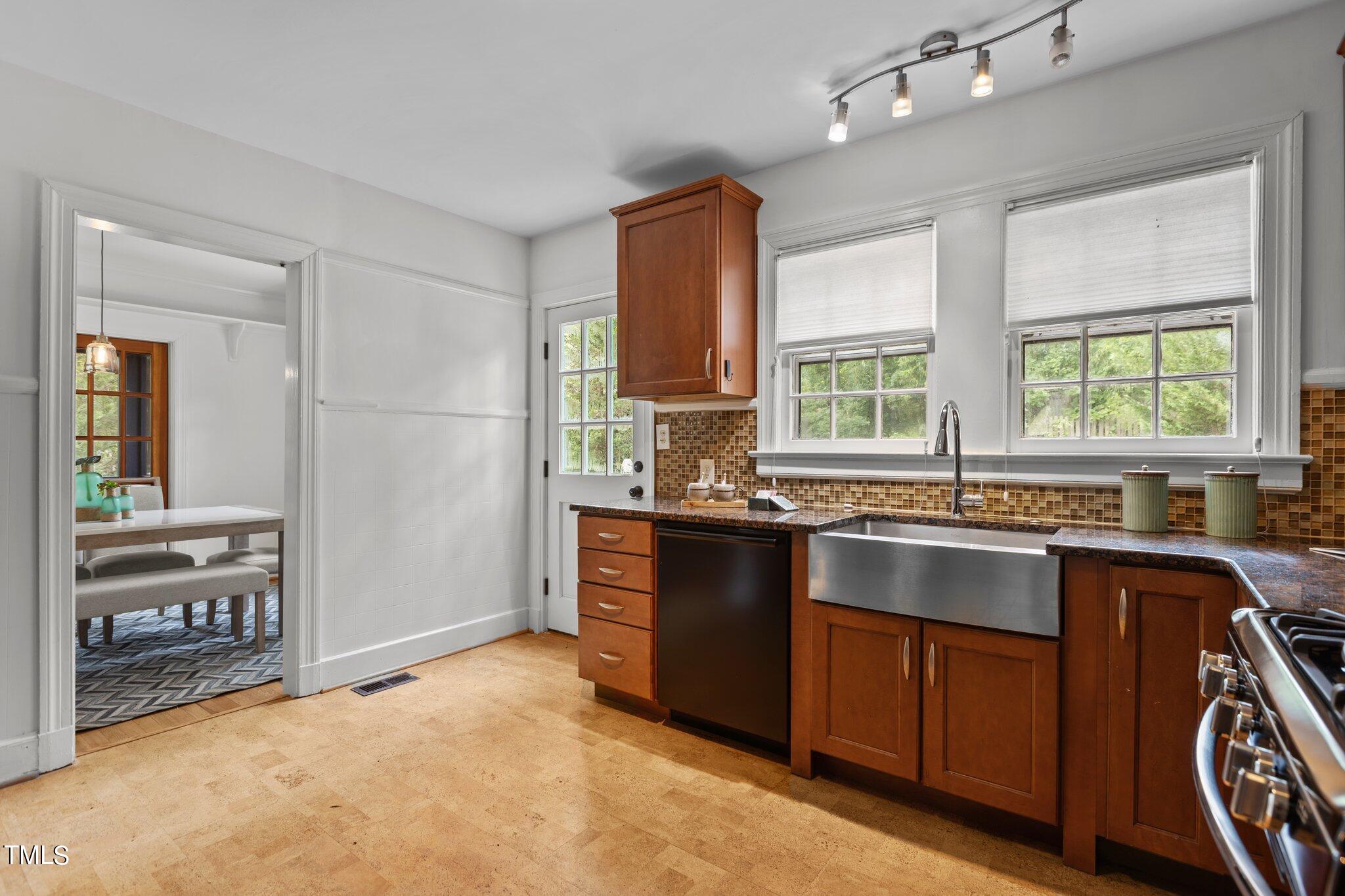 1702 James Street Durham, NC 27707 - Photo 17 of 40 a kitchen with granite countertop a stove a sink and a refrigerator