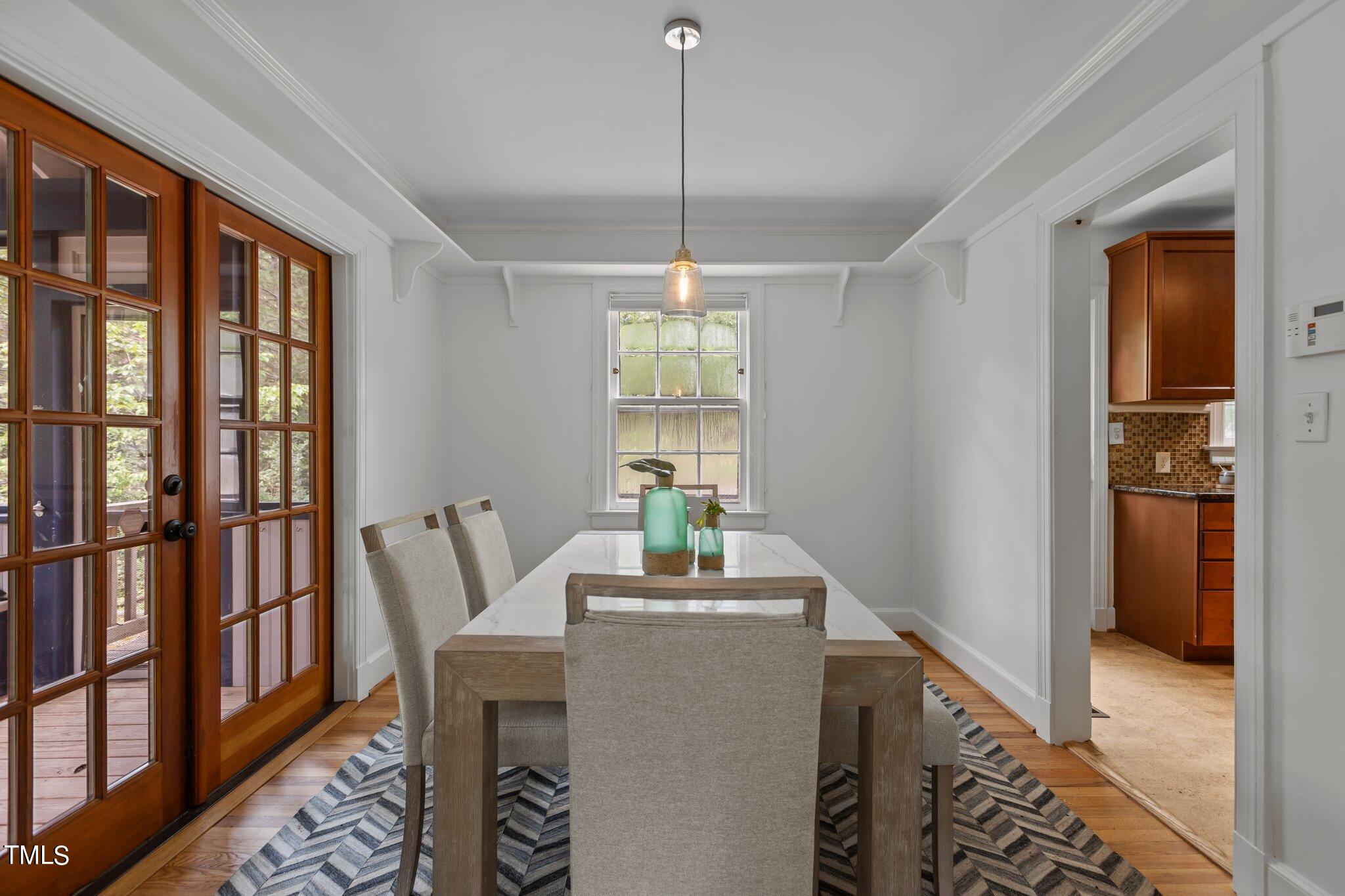 1702 James Street Durham, NC 27707 - Photo 21 of 40 a dining room with furniture window entryway and wooden floor