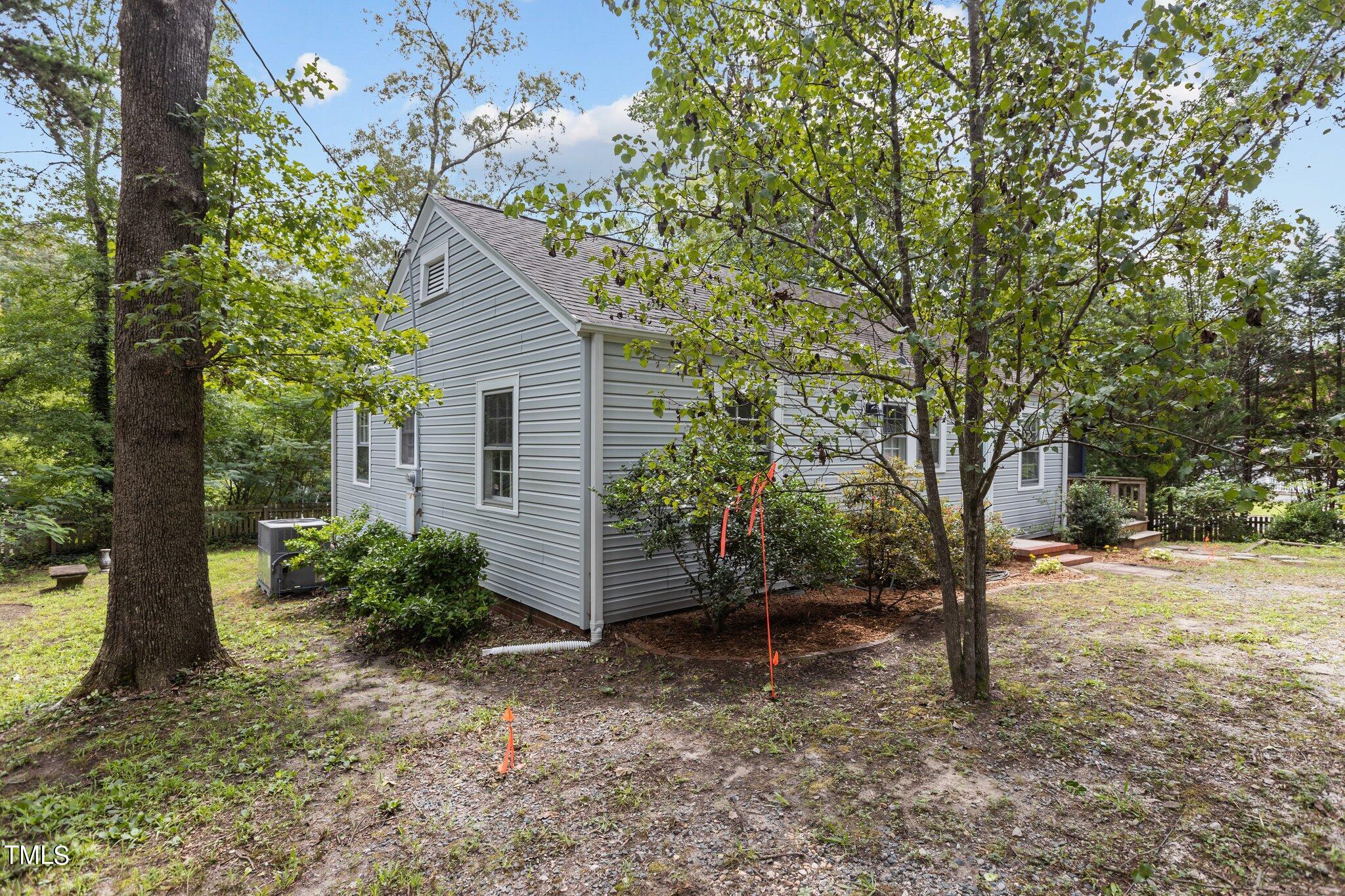 1702 James Street Durham, NC 27707 - Photo 29 of 40 a backyard of a house with plants and large tree