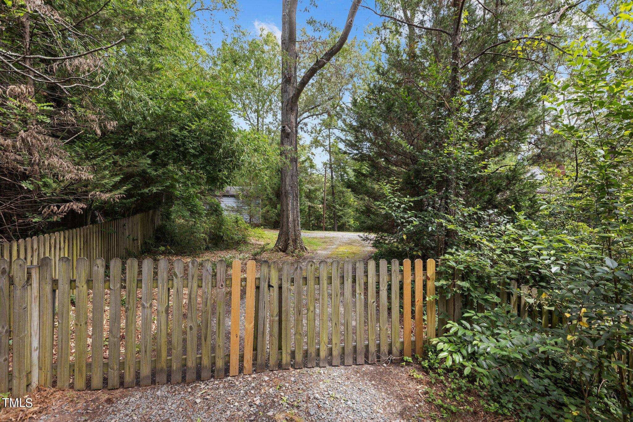 1702 James Street Durham, NC 27707 - Photo 33 of 40 a wooden fence with trees in front of it
