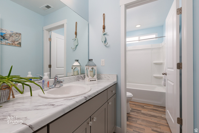 1654 South 730 West Provo, UT 84601 - Photo 16 of 33 Bathroom featuring a single vanity with an integrated sink, a faux marble countertop, and gray cabinetry with clear knob hardware