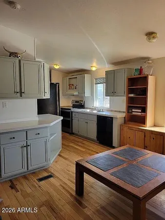 a kitchen with a sink stove and refrigerator