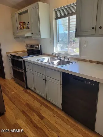 a kitchen with stainless steel appliances a refrigerator and a stove