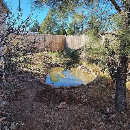 a view of a kitchen with kitchen island a sink stainless steel appliances and cabinets