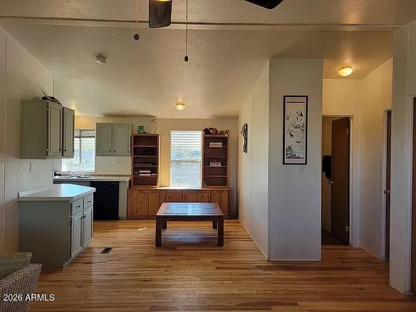 a kitchen with a sink cabinets and wooden floor